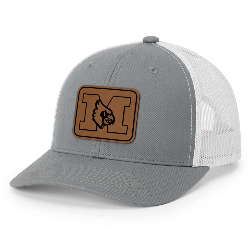 A red and white trucker hat featuring a brown rectangular patch on the front with a black-outlined letter 'M' and a bird mascot logo.